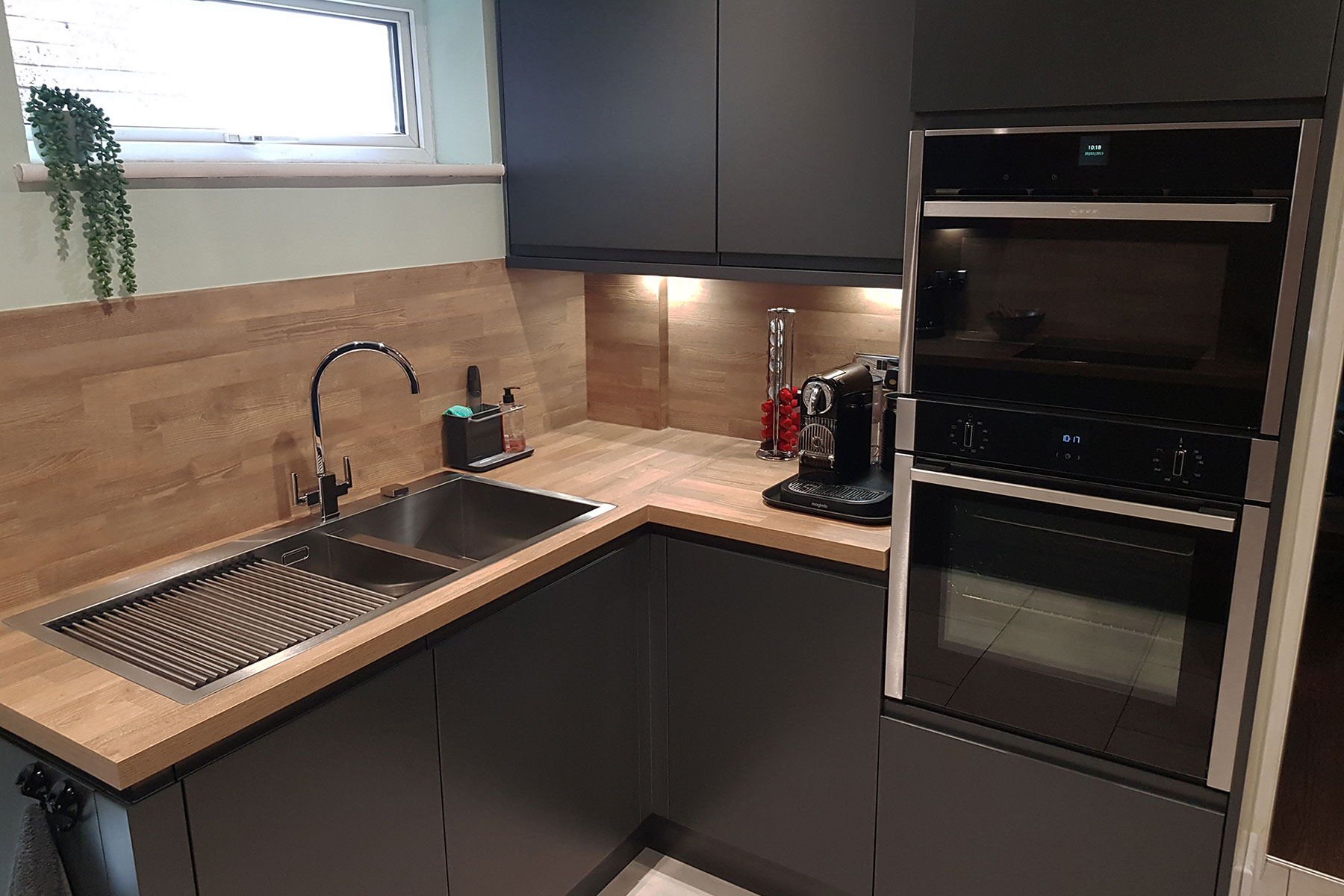 Deep black kitchen with new installed oven by Cheshire life Kitchens in Cheshire